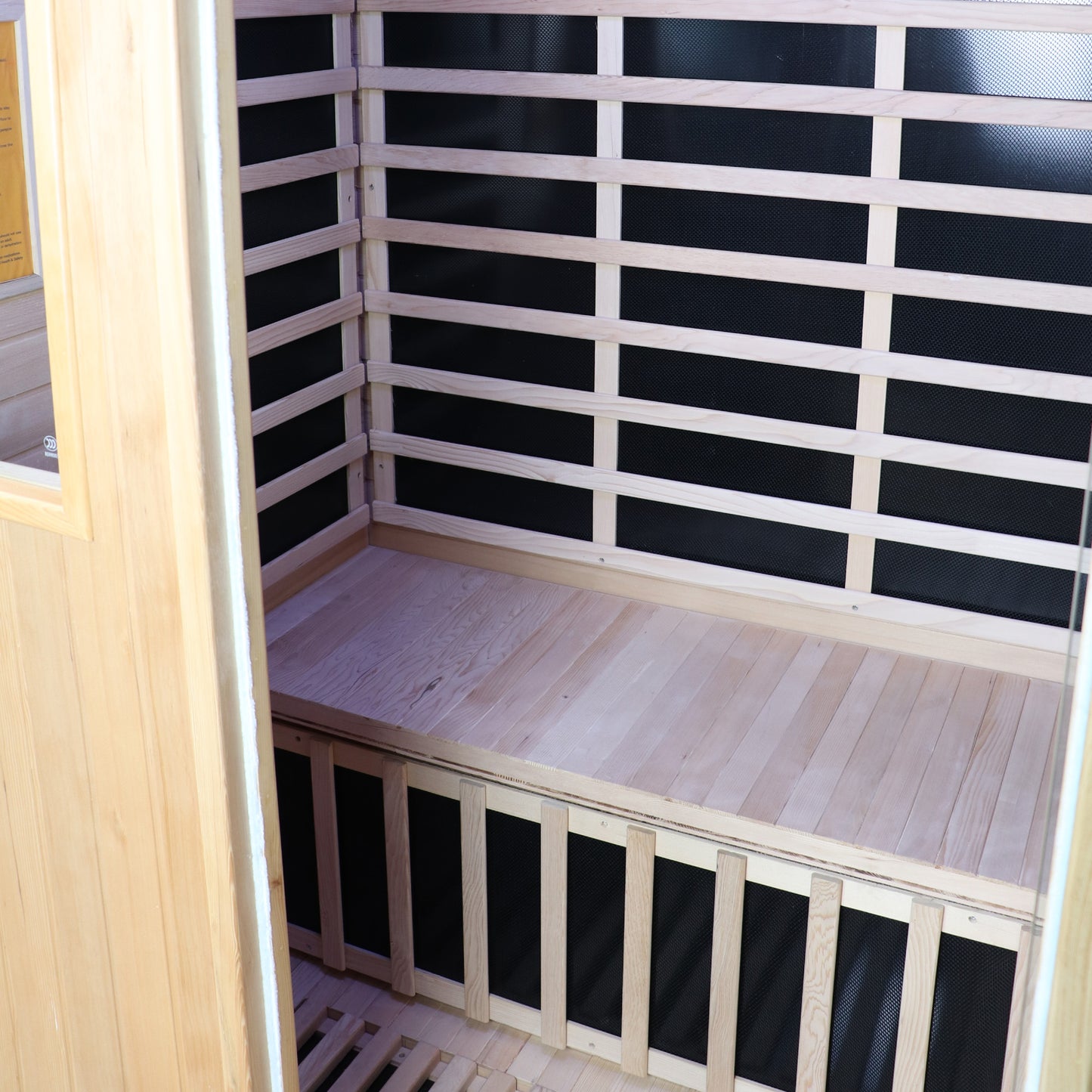 Infrared sauna with wooden floor and black panel walls