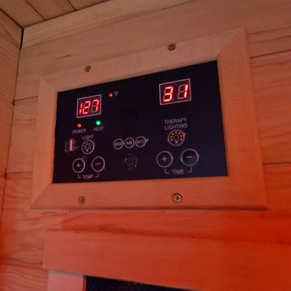Digital control panel with temperature and time display in a wooden sauna.